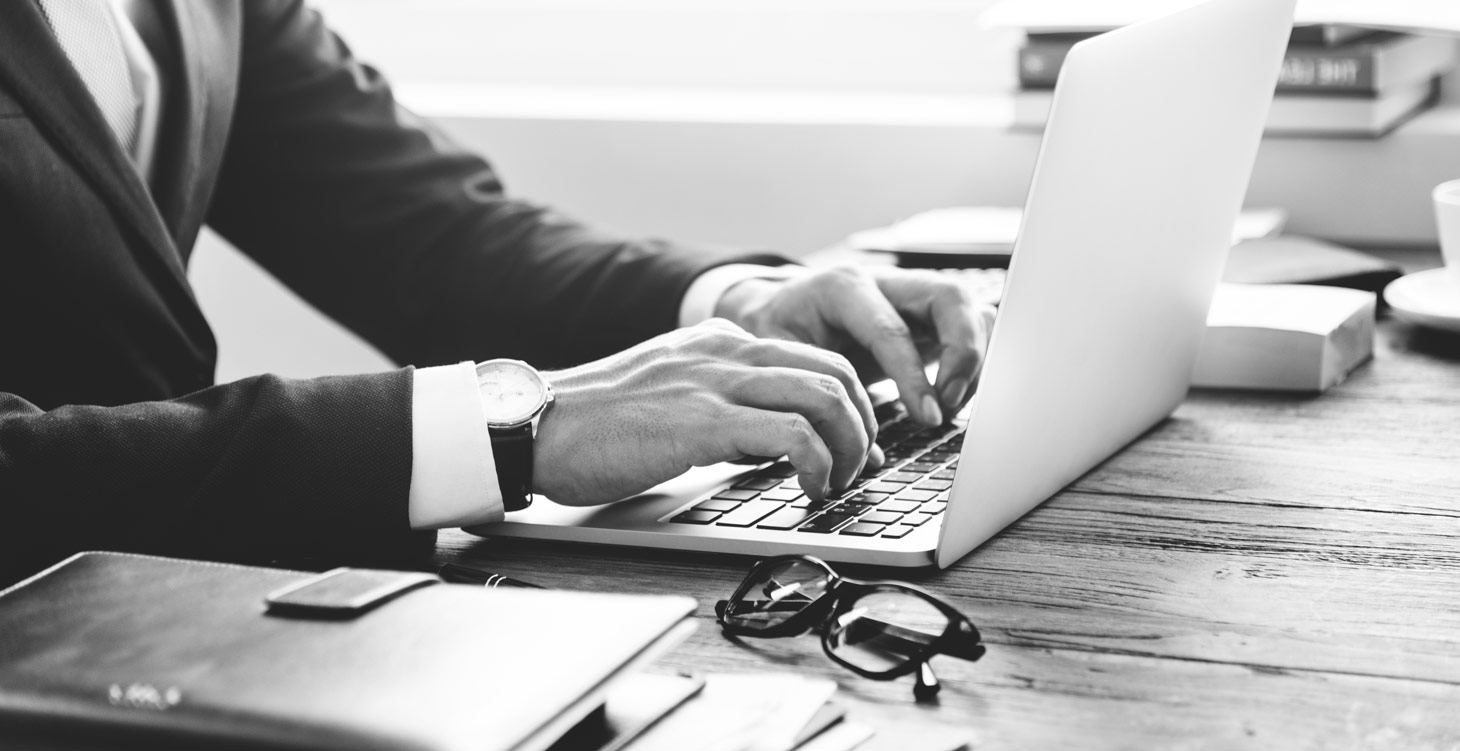 a lawyer types on his computer at his kitchener waterloo office location